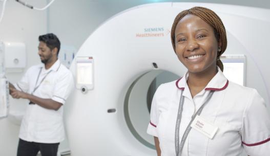 Hashim Maudarbocus, Senior Diagnostic Radiographer (left) and Ebube Adugo, Diagnostic Radiographer (right) located with the CT Scanner at Cavendish Square.
