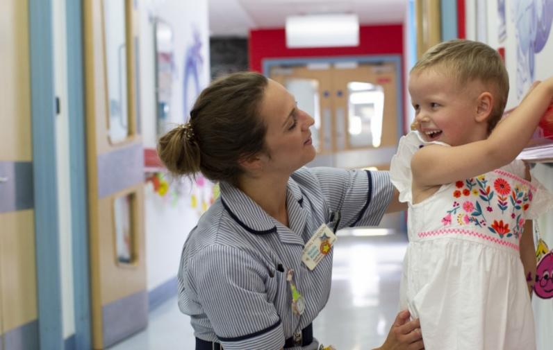 Nurse with child in corridor