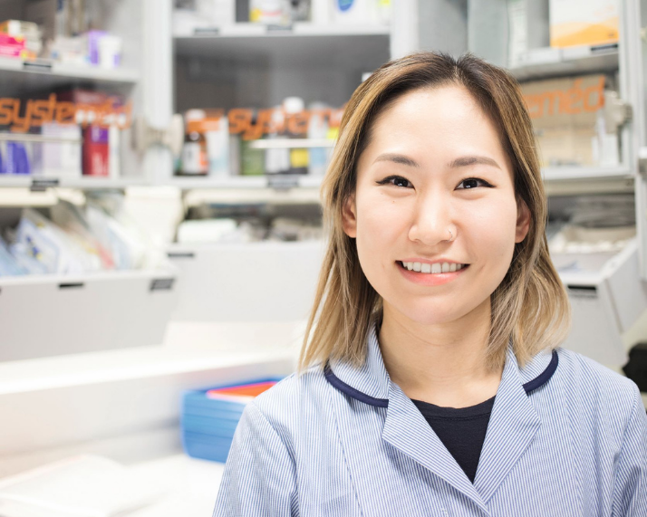 Ashley Oh standing in front of medicine shelves