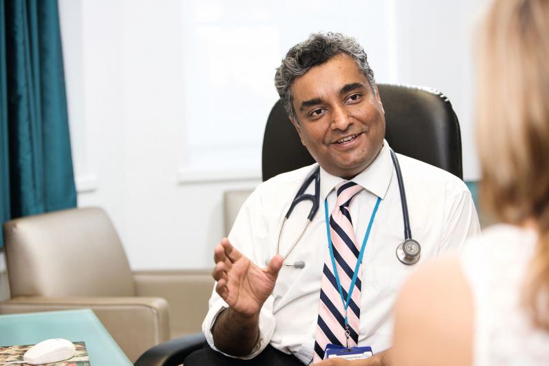 Dr Sanjay Popat, Consultant Thoracic Medical Oncologist, talking to a patient