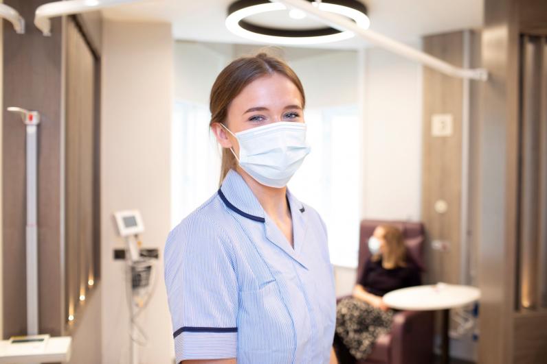 Nurse with patient in background in the Medical Day Unit