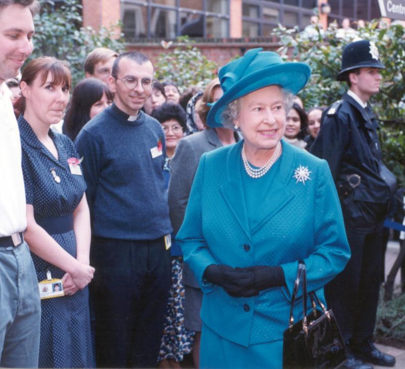 HRH The Queen outside the hospital, surrounded by staff and patients