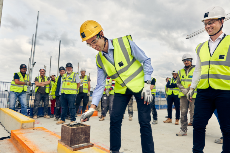 Chief Operating Officer at The Royal Marsden, Karl Munslow Ong, lays the final block of concrete