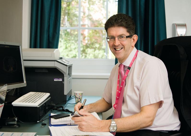 Professor Stephen Johnston sitting at desk